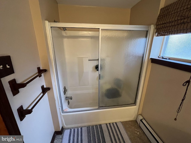 bathroom with combined bath / shower with glass door and a baseboard heating unit