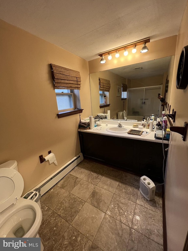 bathroom featuring an enclosed shower, vanity, a textured ceiling, baseboard heating, and toilet