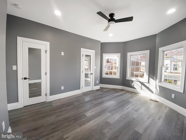 interior space with ceiling fan and dark wood-type flooring