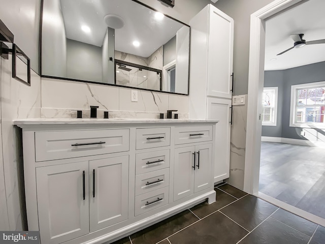 bathroom featuring decorative backsplash, tile patterned floors, walk in shower, vanity, and ceiling fan