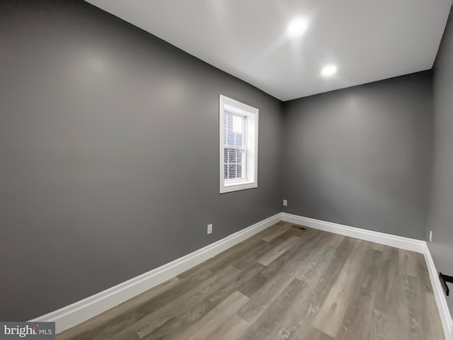 empty room with hardwood / wood-style floors