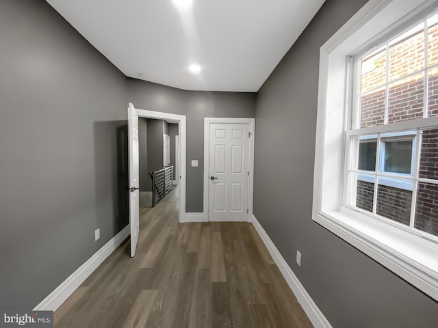 corridor with dark wood-type flooring