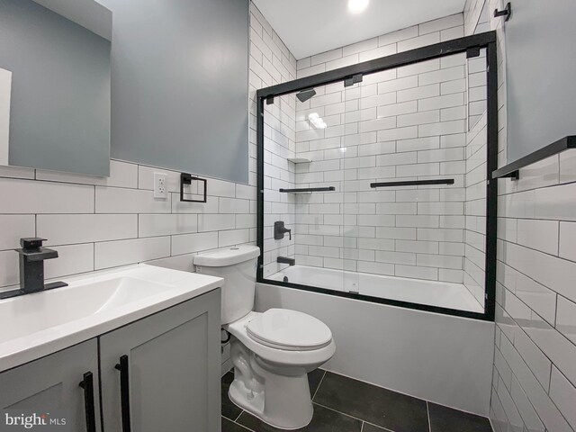 4827 N Warnock St, Philadelphia, PA 19141 - full bath featuring tile walls, vanity, bath / shower combo with glass door, tile patterned floors, and a wainscoted wall