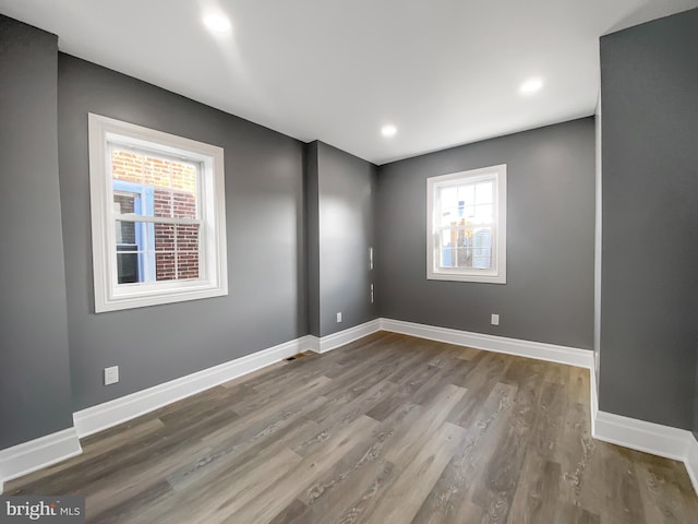 unfurnished room with dark wood-type flooring and a healthy amount of sunlight