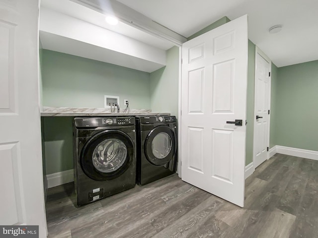 washroom with washer and clothes dryer and dark wood-type flooring