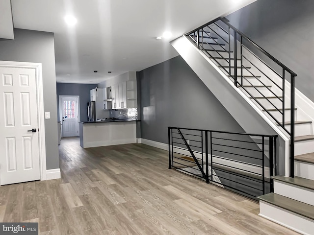 unfurnished living room featuring light hardwood / wood-style flooring