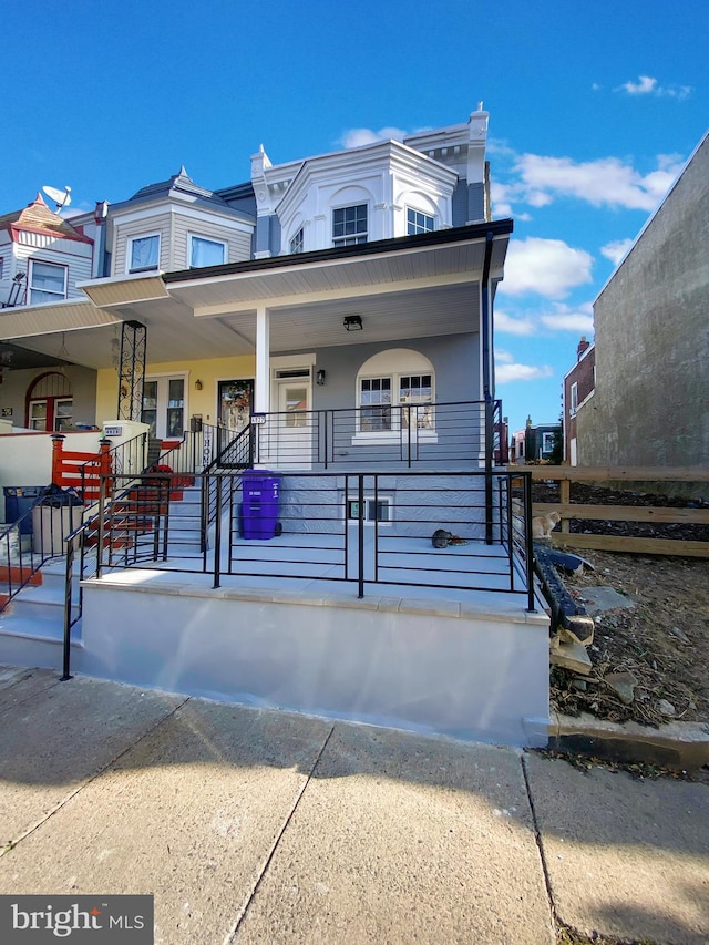 townhome / multi-family property featuring covered porch