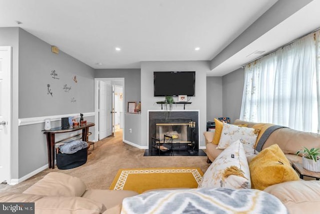 living room with a fireplace and light carpet