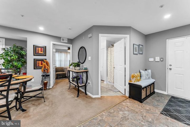 foyer entrance with carpet