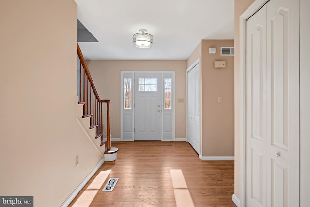 foyer entrance with light wood-type flooring