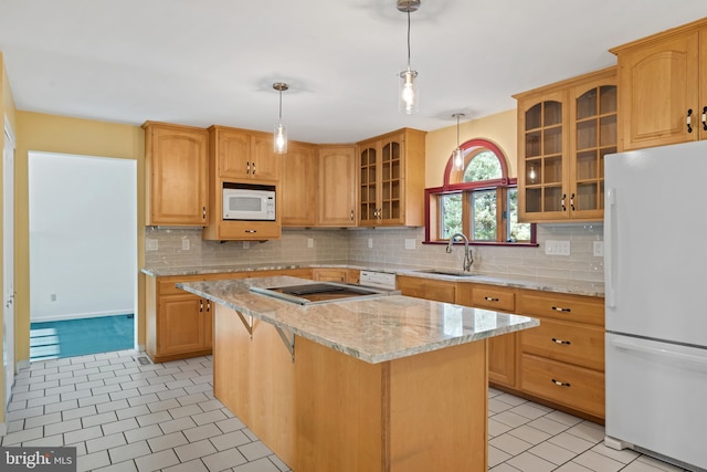 kitchen featuring decorative light fixtures, white appliances, a center island, and backsplash