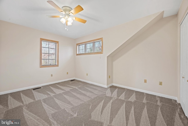 additional living space featuring carpet flooring and ceiling fan