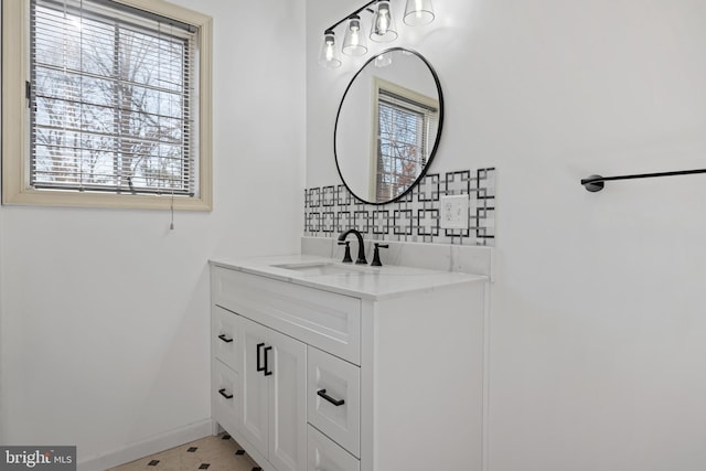 bathroom featuring vanity and backsplash