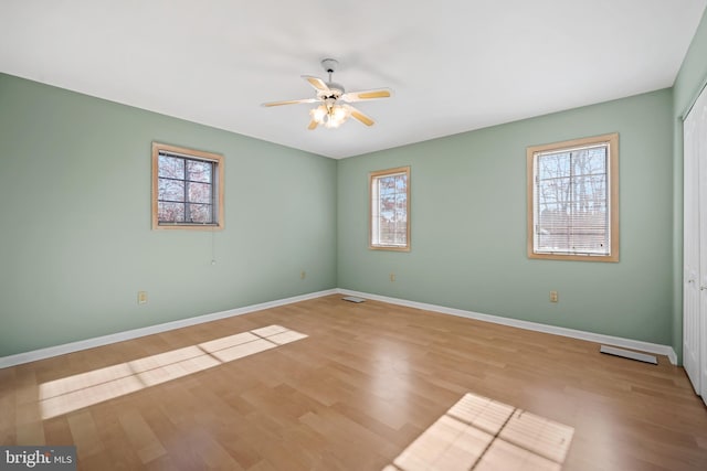 empty room with light hardwood / wood-style floors and ceiling fan