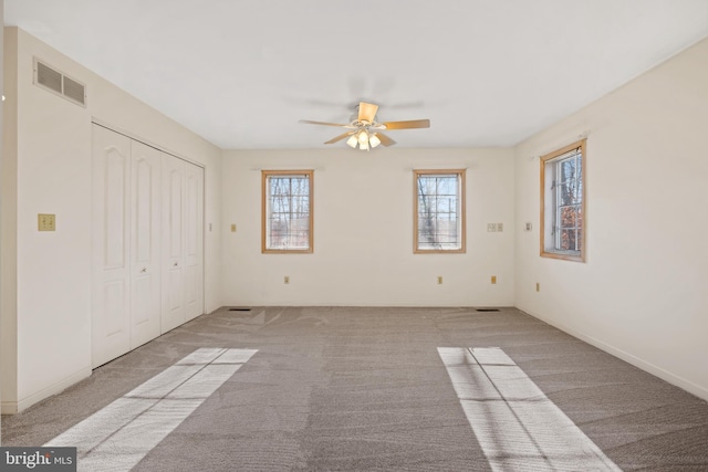 unfurnished bedroom with ceiling fan and light carpet