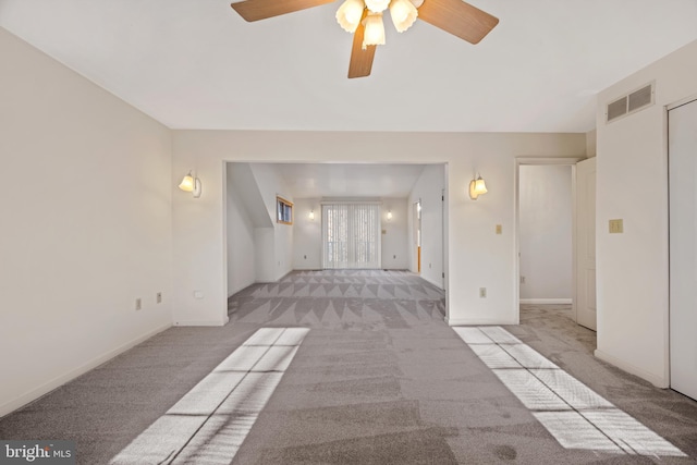 unfurnished living room with ceiling fan and light colored carpet