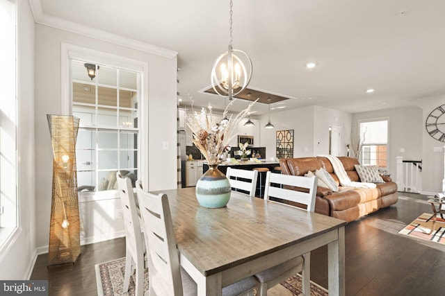 dining area with ornamental molding, dark wood-type flooring, and a chandelier