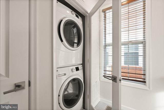 laundry room featuring stacked washer / dryer