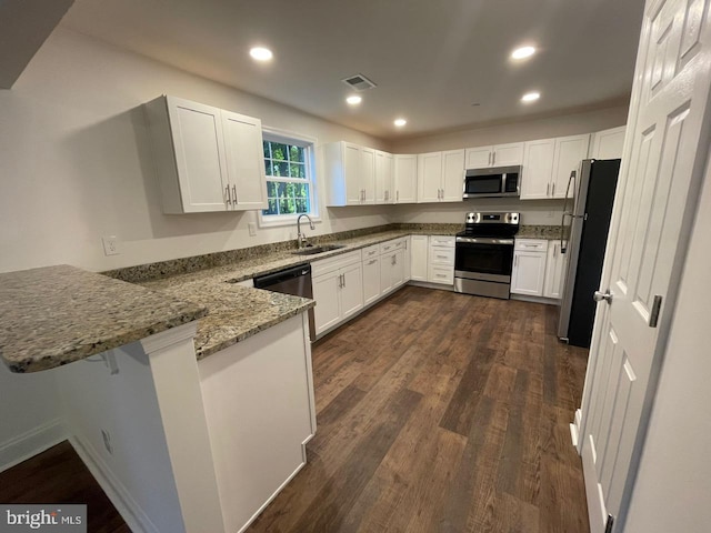 kitchen with white cabinets and appliances with stainless steel finishes