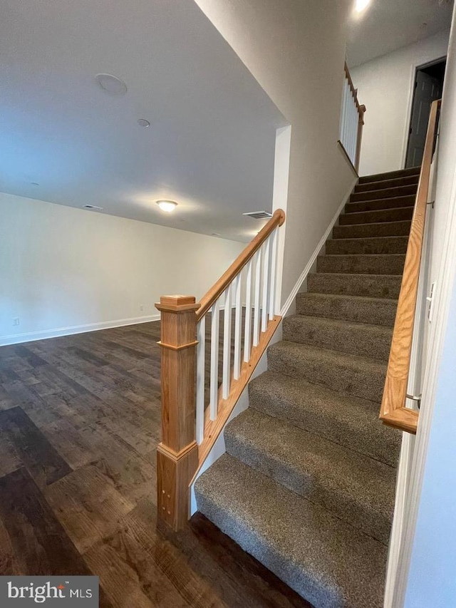 stairway featuring hardwood / wood-style floors