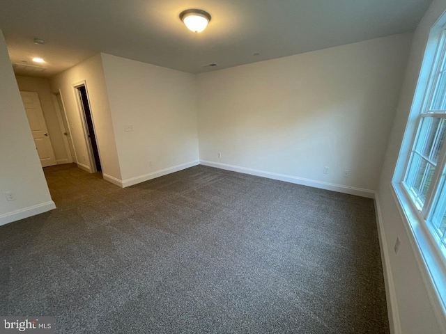 empty room with dark carpet