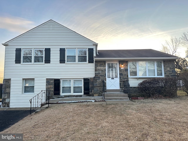 tri-level home with a lawn