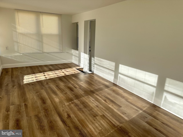 empty room featuring wood-type flooring