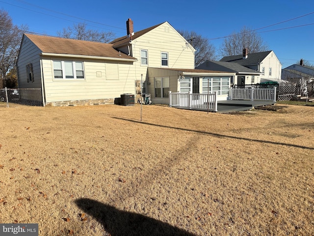 back of property featuring a yard, a deck, and central air condition unit