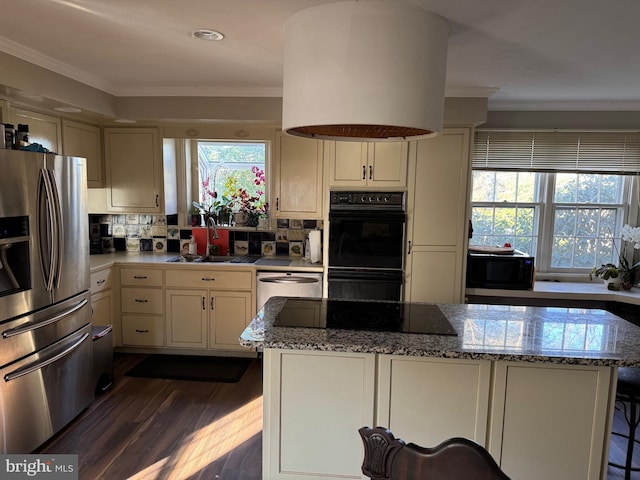 kitchen featuring dark wood-type flooring, black appliances, sink, light stone countertops, and tasteful backsplash