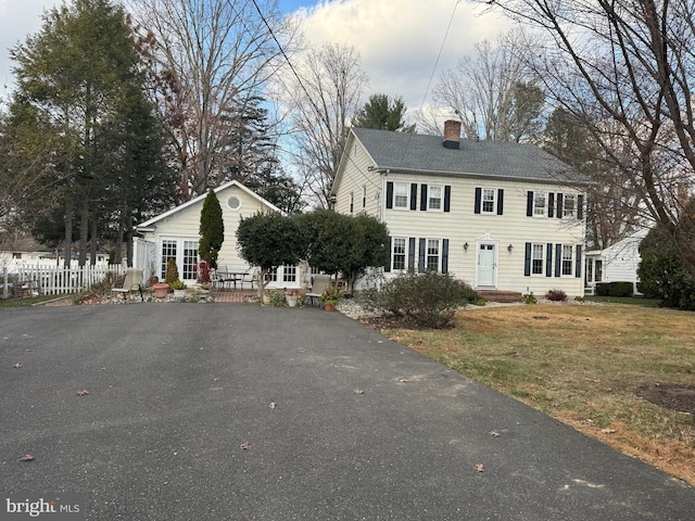 colonial-style house with a front yard