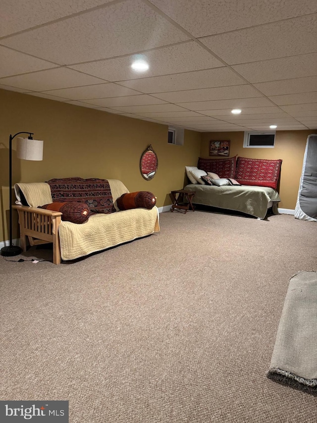 carpeted bedroom featuring a paneled ceiling