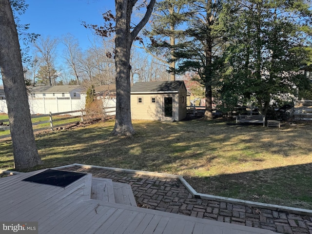 view of yard featuring an outdoor structure and a wooden deck