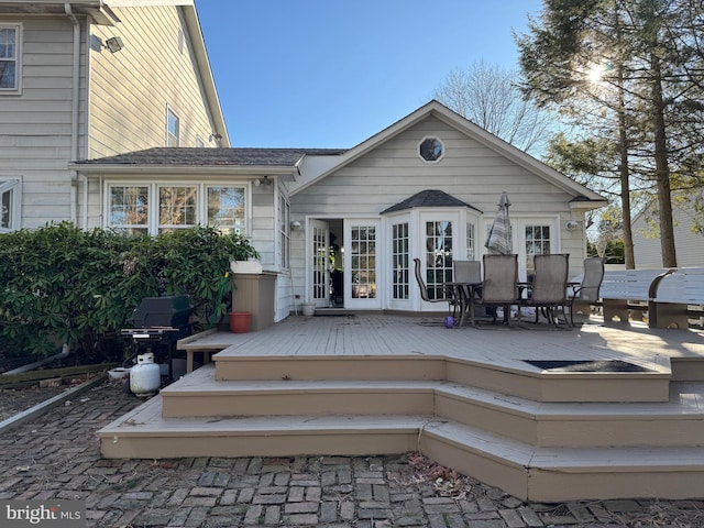 rear view of property with a wooden deck