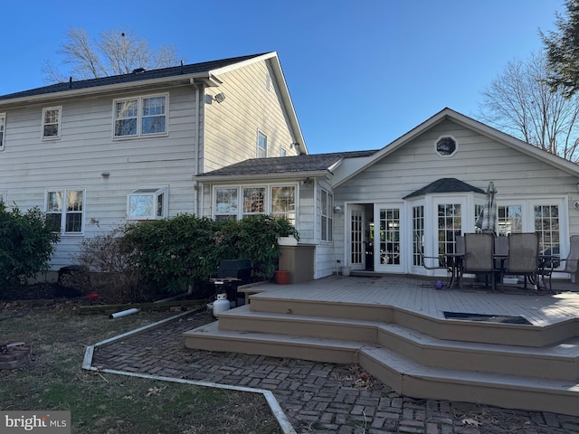 back of property featuring a deck