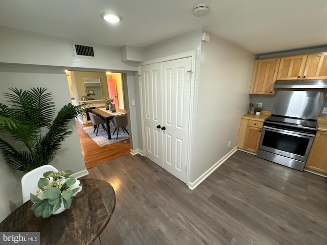 kitchen with light brown cabinetry, stainless steel range with electric stovetop, and dark wood-type flooring