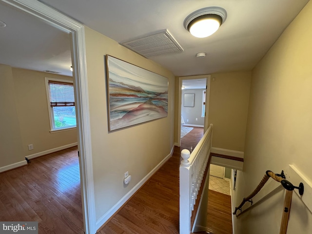 corridor with hardwood / wood-style flooring