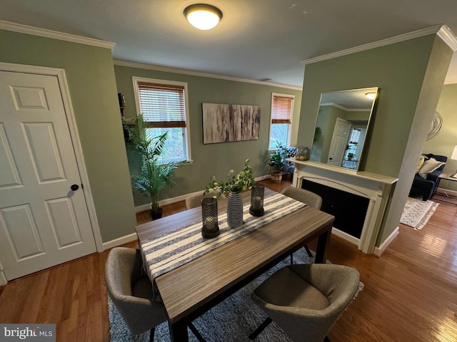 dining area featuring wood-type flooring and ornamental molding