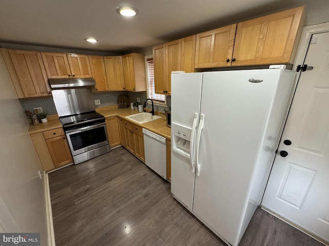 kitchen featuring decorative backsplash, white appliances, sink, light brown cabinets, and dark hardwood / wood-style floors