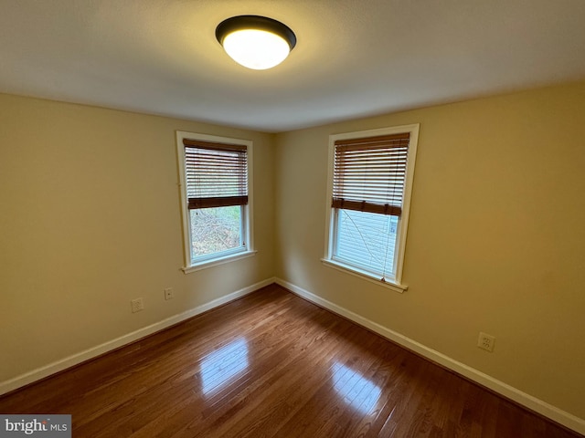 unfurnished room with hardwood / wood-style floors