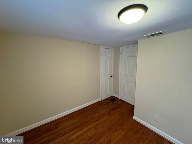 spare room with dark hardwood / wood-style flooring