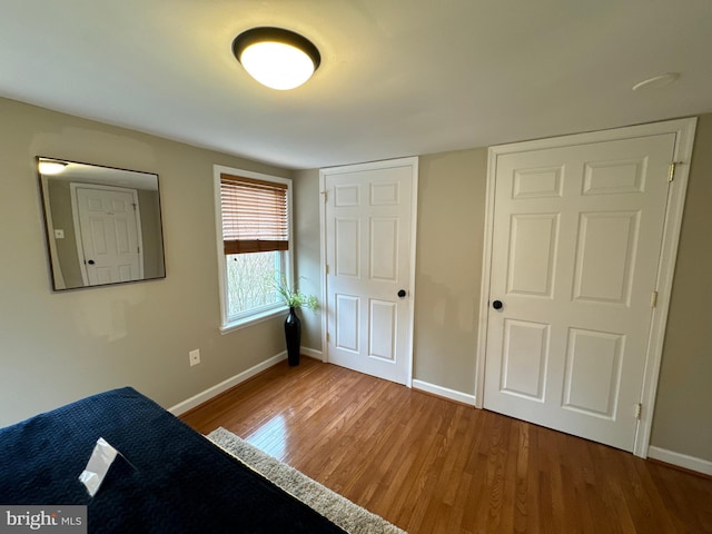 unfurnished bedroom with hardwood / wood-style flooring