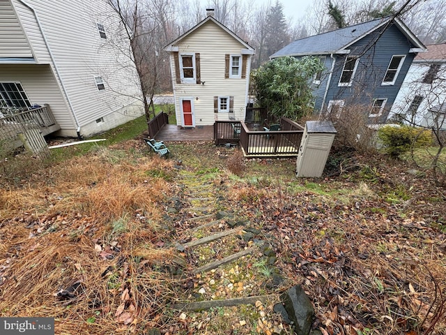 rear view of house with a wooden deck