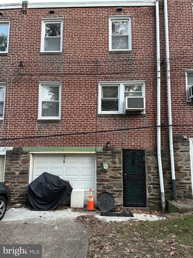 back of house with a garage