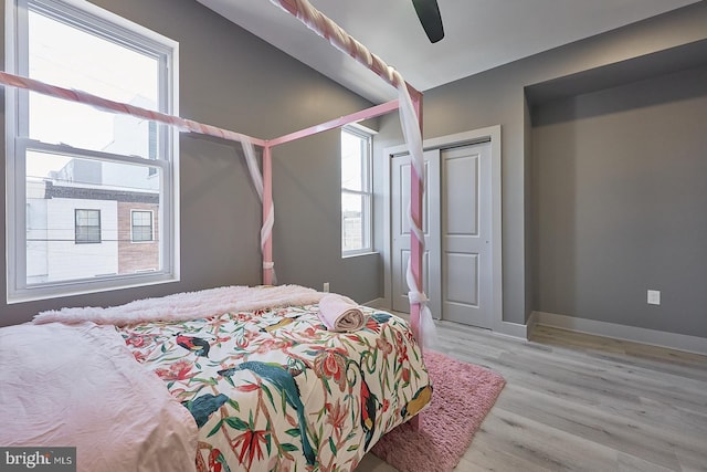 bedroom with ceiling fan and light hardwood / wood-style flooring