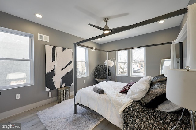 bedroom with hardwood / wood-style floors and ceiling fan