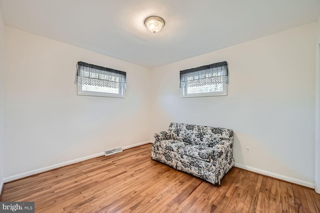 sitting room with a wealth of natural light and light hardwood / wood-style flooring