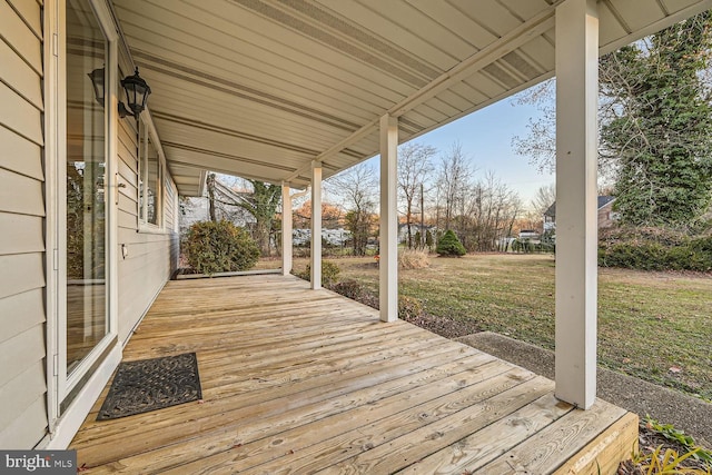 deck with a lawn and covered porch