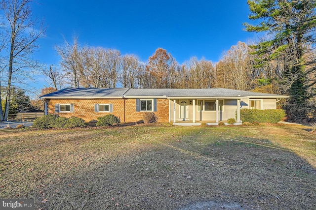 ranch-style home with a front yard and covered porch