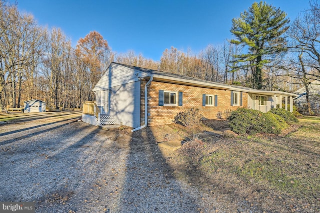 view of property exterior with a garage and an outdoor structure