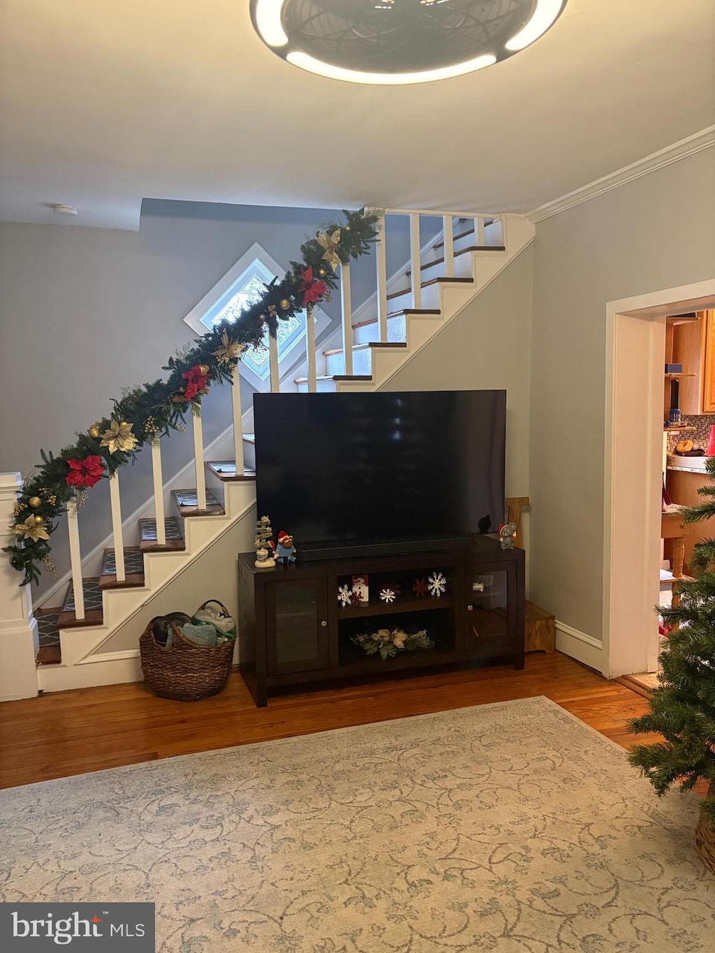 living room featuring hardwood / wood-style flooring and ornamental molding